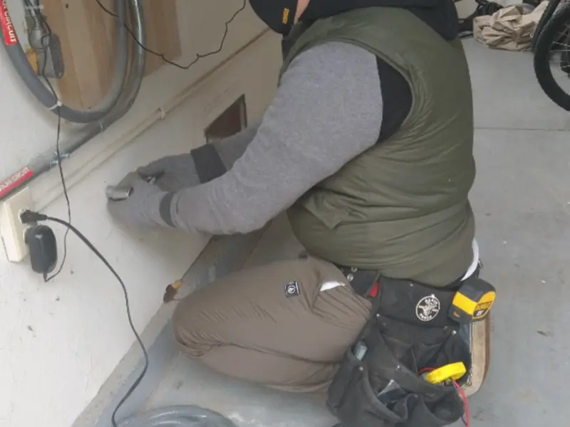 Electrician performing outlet wiring in a Vandalia garage